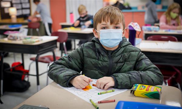Boy works on paper kite